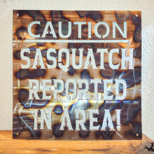 Load image into Gallery viewer, Metal &quot;Caution Sasquatch Reported In Area&quot; Hanging Sign